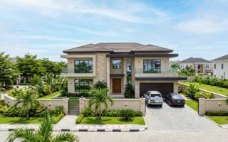Nigerian property buyer inspecting land with a real estate professional before purchase