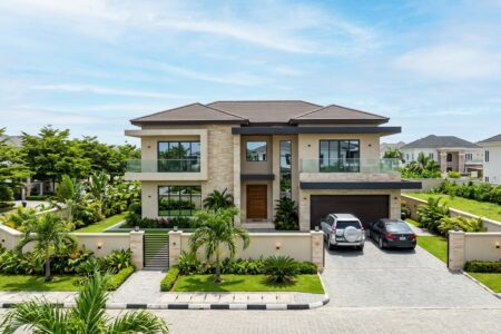 Nigerian property buyer inspecting land with a real estate professional before purchase